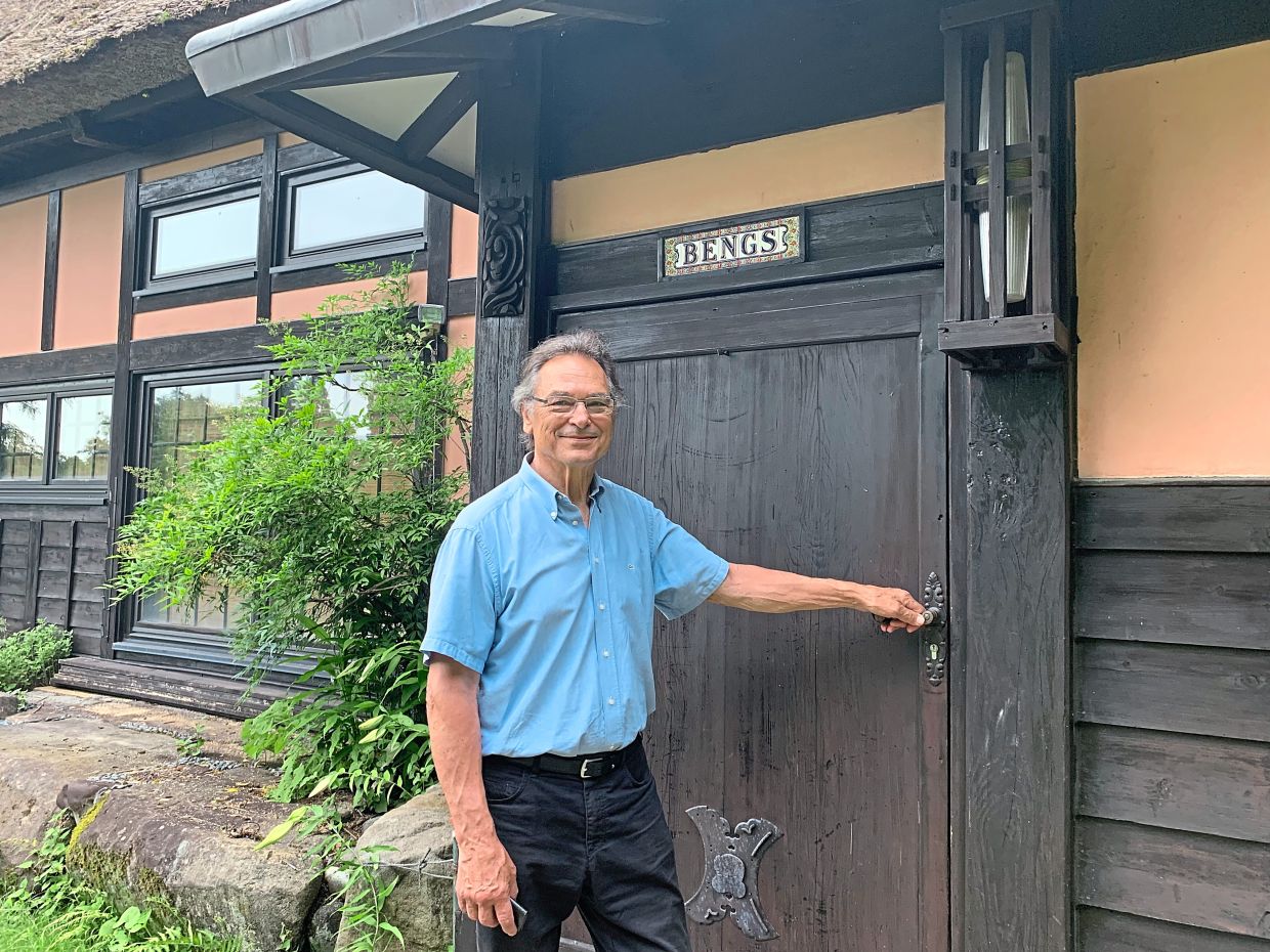 Bengs standing in front of his home in the mountains of Niigata prefecture. Combining the traditional and the new, the family name is displayed in German lettering above the door of the Japanese country house. Photos: Lars Nicolaysen/dpa