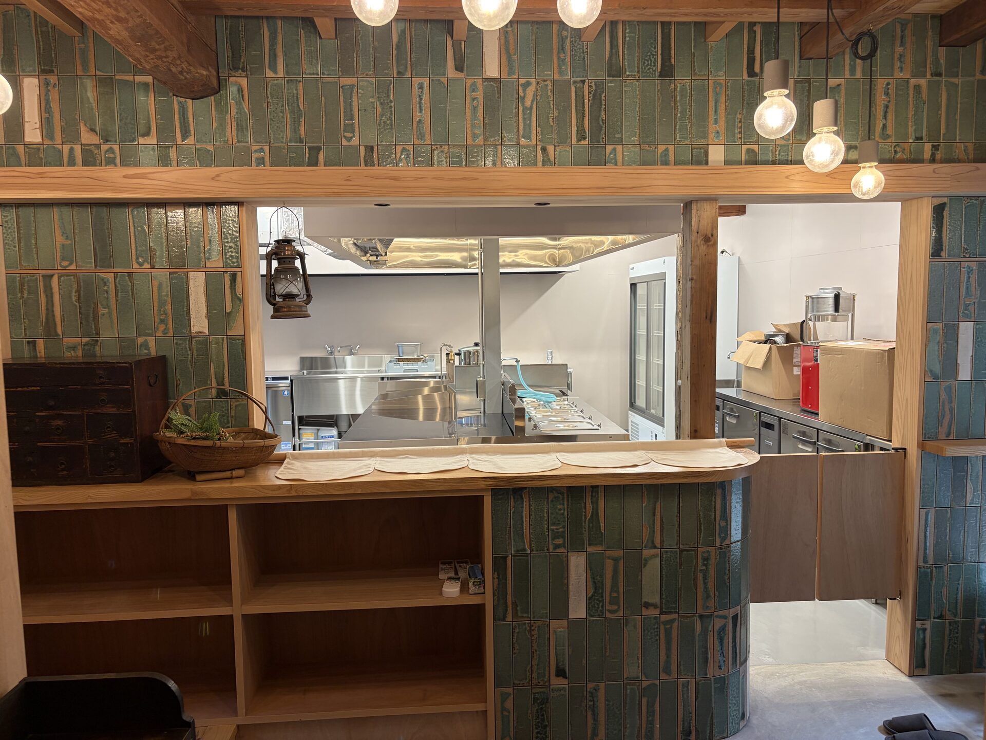 Wooden service counter connecting the restored dining room with the commercial kitchen