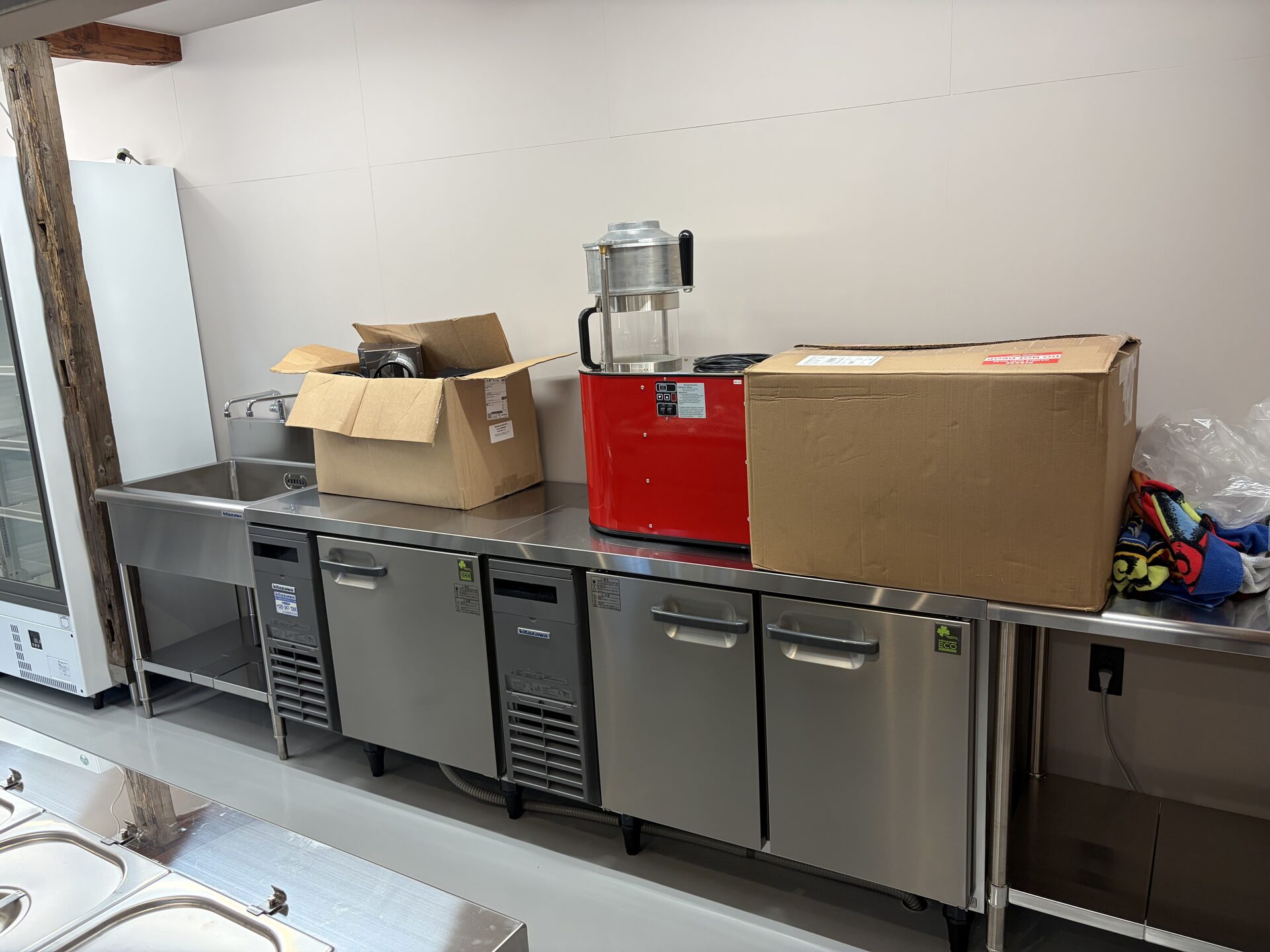 Stainless steel undercounter refrigeration and preparation counter in the completed kitchen